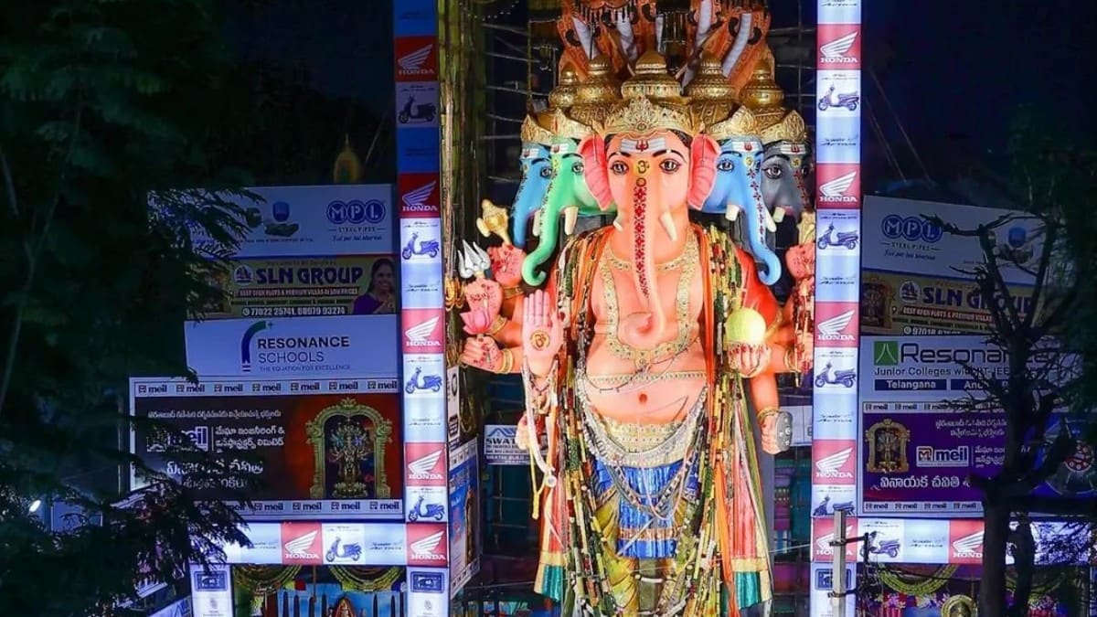 Large crowd of devotees waiting in line to view the 69-foot tall Panchamukha Sankatahara Maha Ganapati idol at the Khairatabad pandal in Hyderabad.